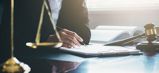 justice scale with a lawyer in the back